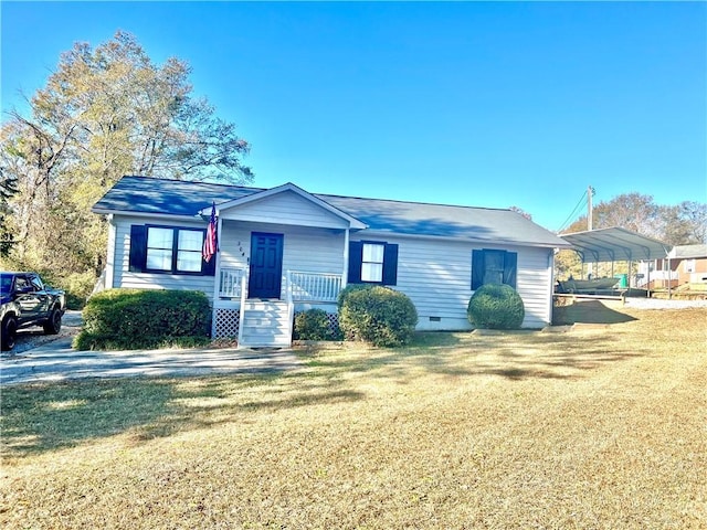 view of front of house with a front lawn and a carport