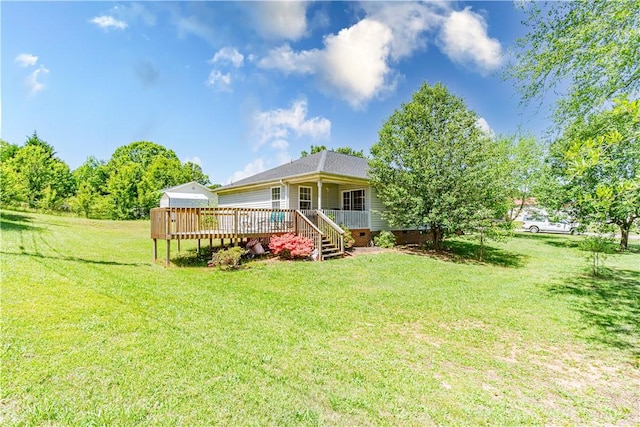 back of house featuring a lawn and a wooden deck