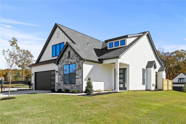 modern farmhouse with a front yard and a garage