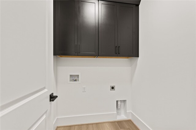 laundry room with cabinets, washer hookup, light hardwood / wood-style floors, and electric dryer hookup