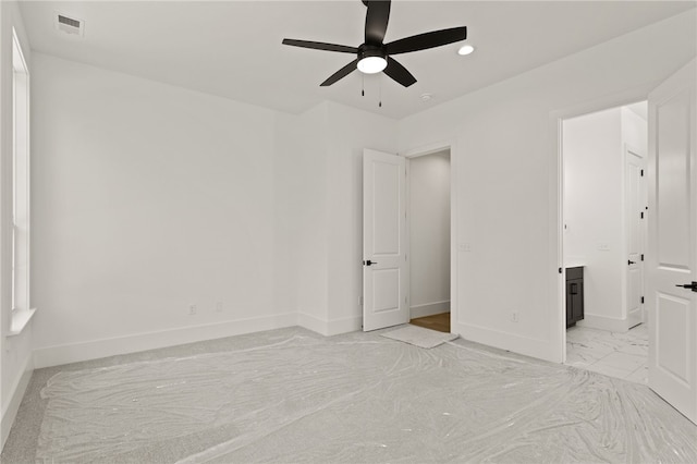 unfurnished bedroom with ensuite bathroom and ceiling fan