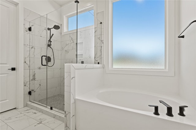 bathroom featuring separate shower and tub
