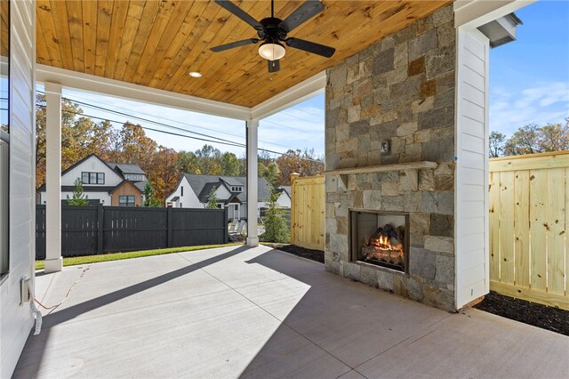 view of patio featuring ceiling fan and an outdoor stone fireplace
