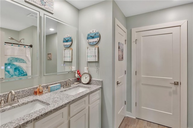 bathroom featuring hardwood / wood-style floors, vanity, and a shower with curtain