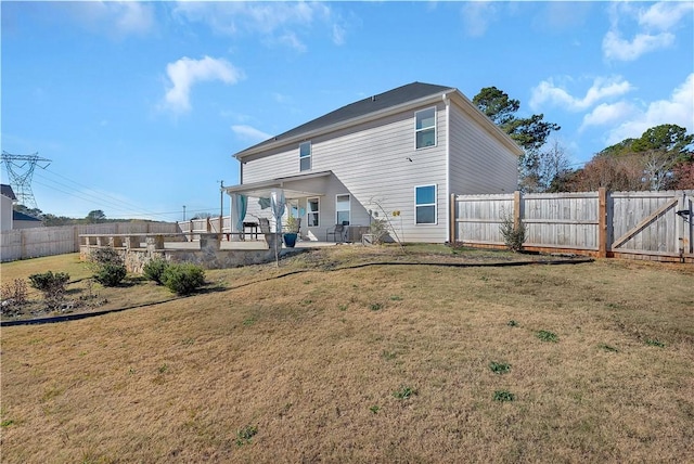 rear view of house with a yard and a patio