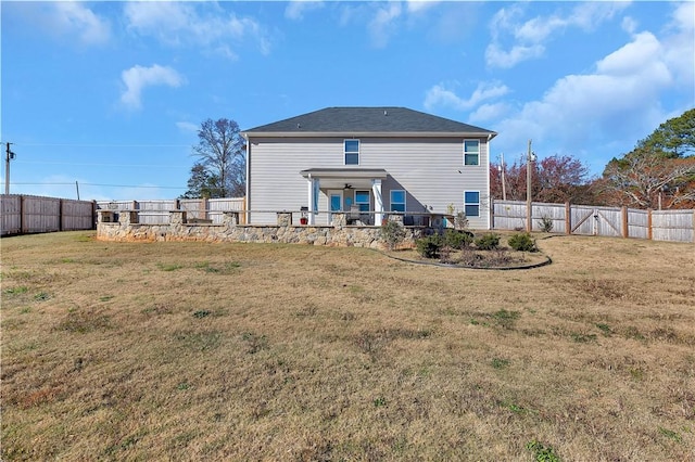 back of house featuring a yard