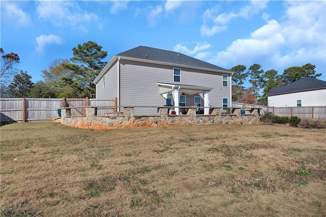 back of house with a lawn