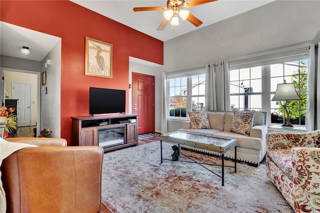 living room featuring ceiling fan and a healthy amount of sunlight