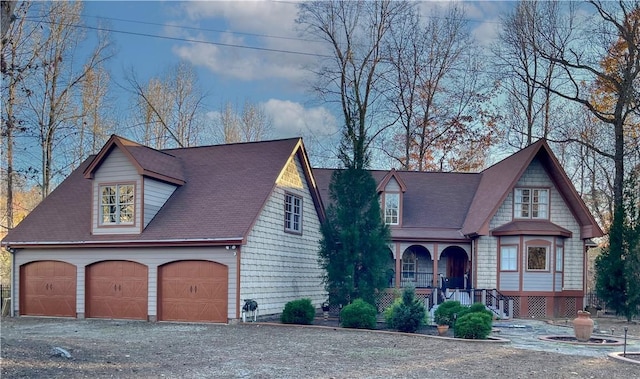 view of front of house featuring covered porch and a garage