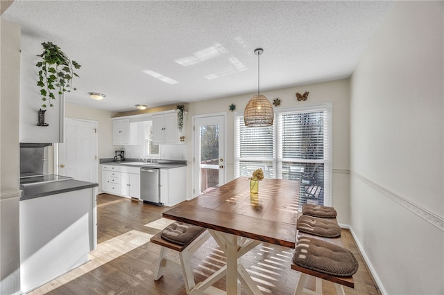 dining space featuring dark hardwood / wood-style flooring and a textured ceiling