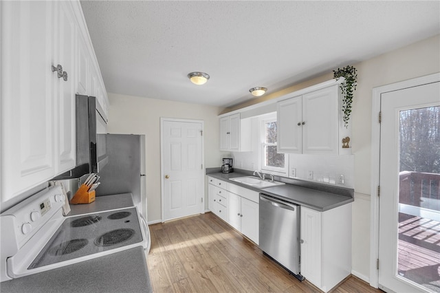 kitchen with sink, white cabinets, stainless steel appliances, and light wood-type flooring