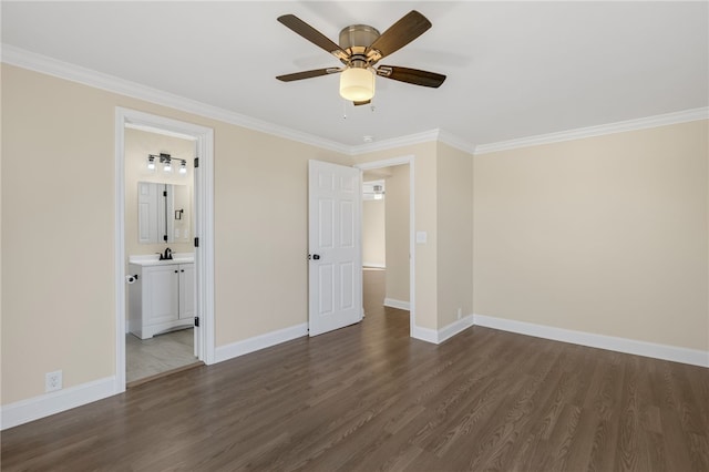 unfurnished bedroom with ensuite bath, ceiling fan, crown molding, and dark wood-type flooring