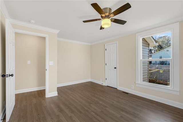 unfurnished room featuring ceiling fan, dark hardwood / wood-style floors, and ornamental molding