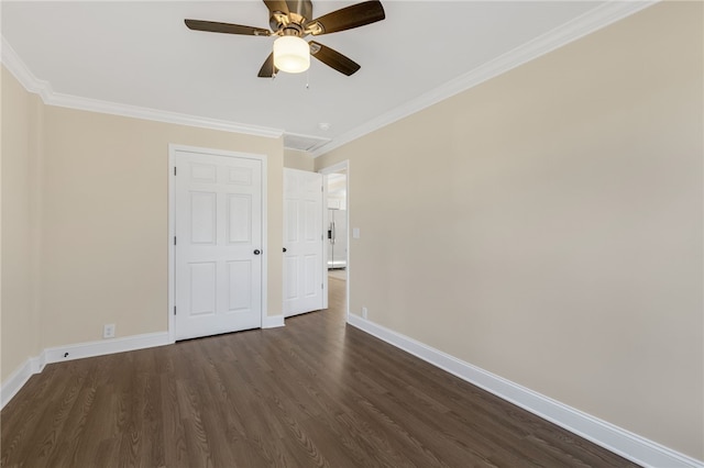 empty room with crown molding, dark hardwood / wood-style flooring, and ceiling fan