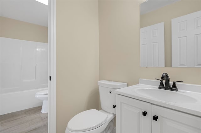 full bathroom featuring hardwood / wood-style floors, vanity, shower / bathtub combination, and toilet