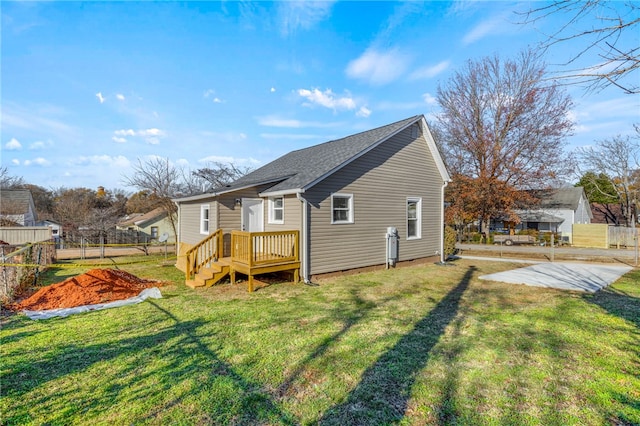 rear view of property with a yard