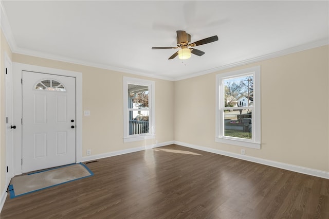 entrance foyer featuring dark hardwood / wood-style floors, crown molding, and a healthy amount of sunlight