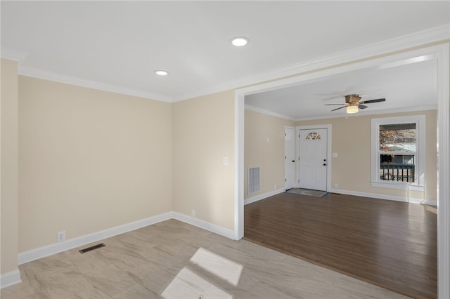 foyer entrance with light hardwood / wood-style floors, ceiling fan, and crown molding