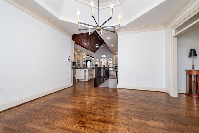 unfurnished living room featuring a chandelier, dark hardwood / wood-style flooring, and ornamental molding