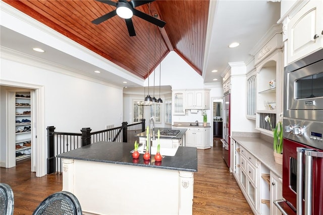 kitchen featuring wood ceiling, stainless steel appliances, white cabinets, dark hardwood / wood-style floors, and an island with sink