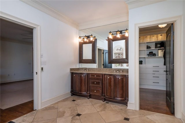 bathroom featuring hardwood / wood-style floors, vanity, and ornamental molding