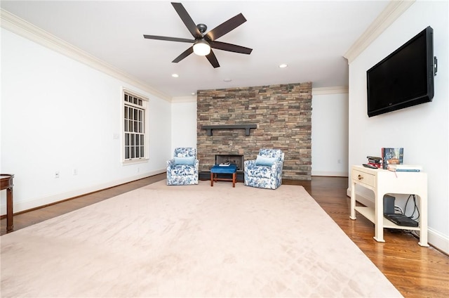 living room with dark hardwood / wood-style floors, ceiling fan, and ornamental molding