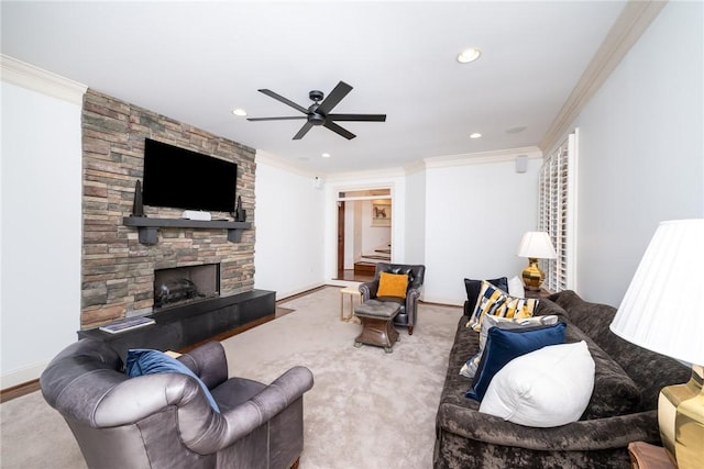 carpeted living room with a stone fireplace, ceiling fan, and crown molding