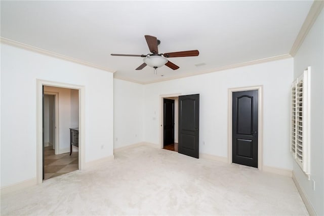 unfurnished bedroom with ceiling fan, light colored carpet, and ornamental molding