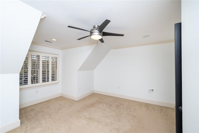 additional living space with ceiling fan and light colored carpet