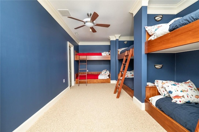 carpeted bedroom featuring ceiling fan and crown molding