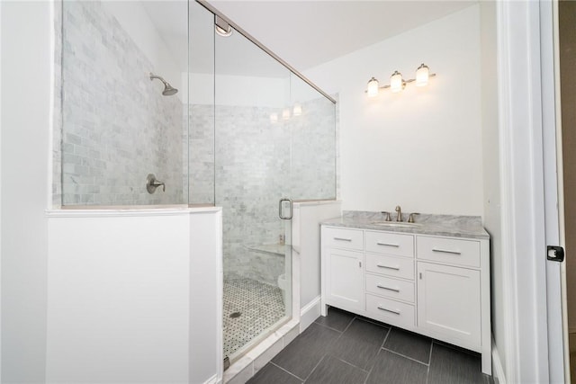 bathroom with vanity and a shower with door