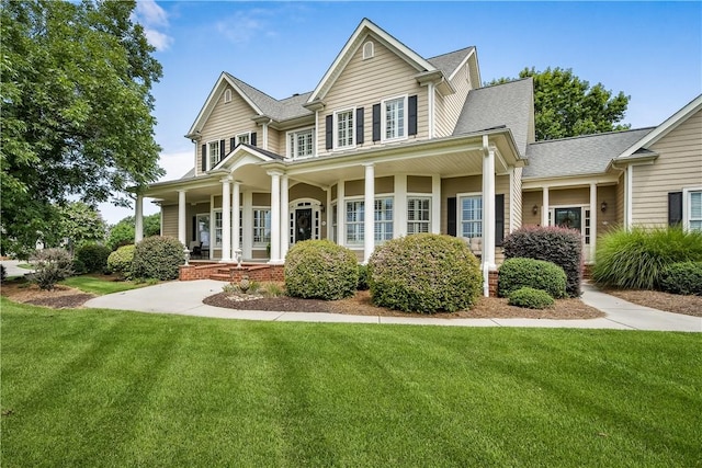 view of front of property with covered porch and a front yard