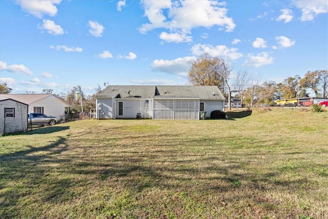 rear view of property with a yard