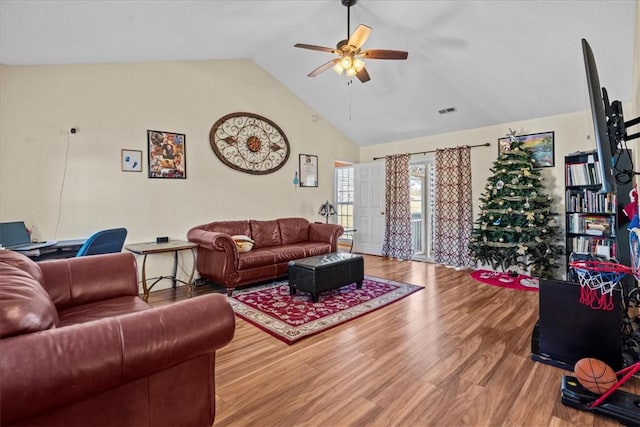 living room with hardwood / wood-style flooring, ceiling fan, and lofted ceiling