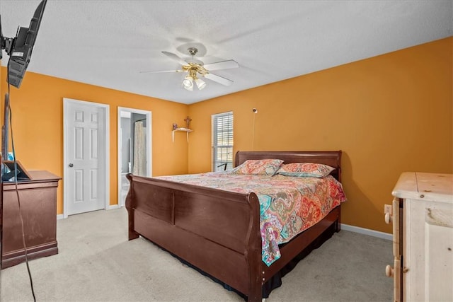 carpeted bedroom with a textured ceiling and ceiling fan