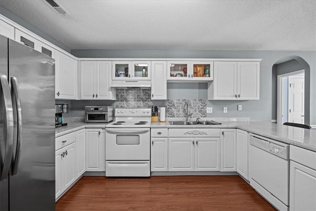 kitchen with white cabinetry, sink, dark wood-type flooring, a textured ceiling, and white appliances