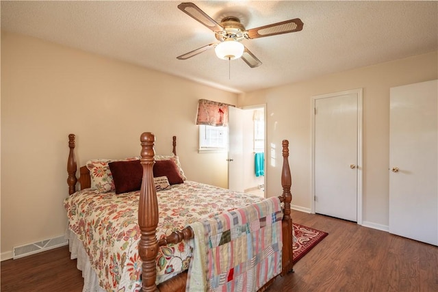 bedroom featuring a textured ceiling, ceiling fan, and dark hardwood / wood-style floors