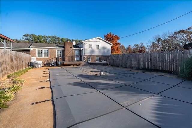 back of house featuring a patio area and a pool side deck