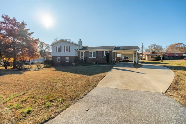 split level home featuring a carport and a front yard