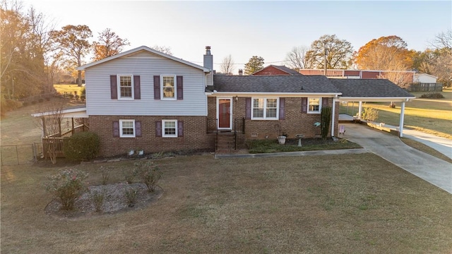 view of front of house with a front yard and a carport