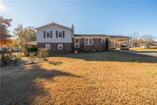 tri-level home featuring a carport and a front yard