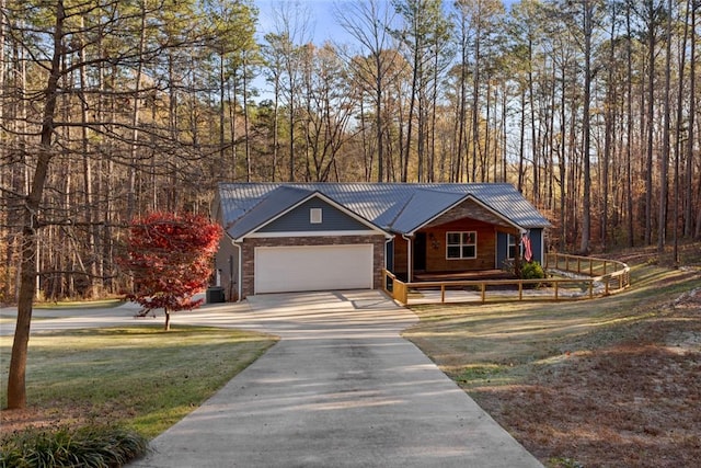 view of front of home featuring a front yard, a garage, and central air condition unit