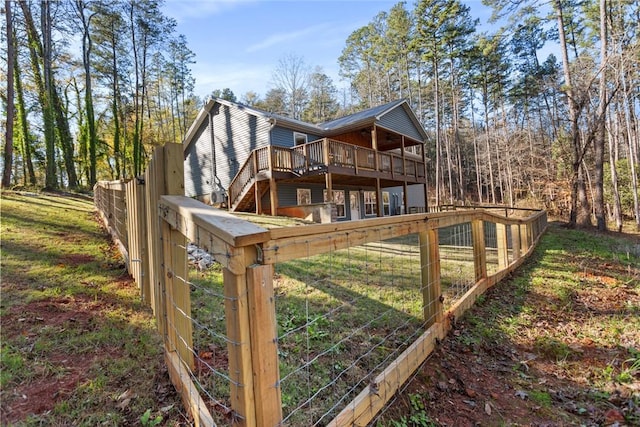 rear view of property featuring a wooden deck