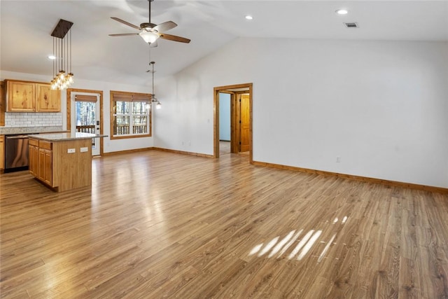 unfurnished living room with ceiling fan, lofted ceiling, and light wood-type flooring