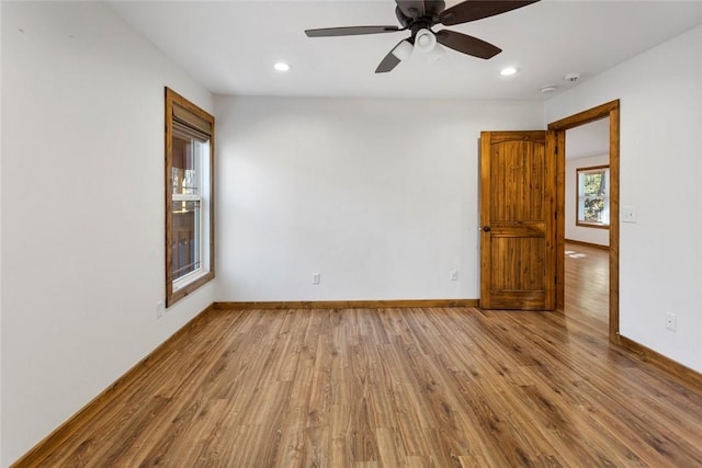 unfurnished room with ceiling fan and light wood-type flooring