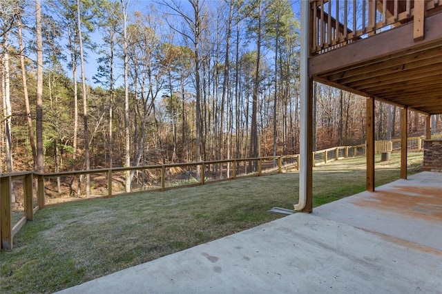 view of yard with a wooden deck and a patio