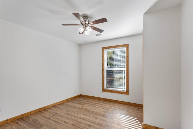 spare room with ceiling fan and light wood-type flooring