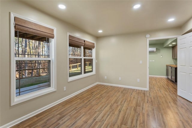 interior space featuring light hardwood / wood-style flooring and a wall mounted AC