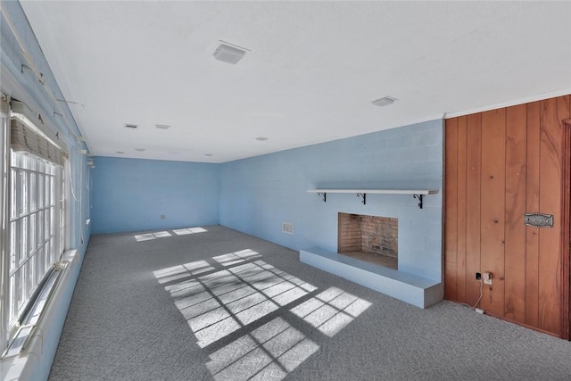 unfurnished living room with a wealth of natural light and light carpet