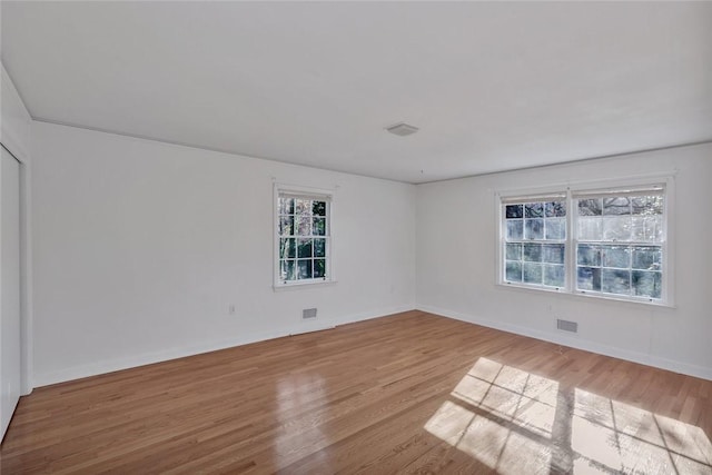 unfurnished room with light hardwood / wood-style floors and a wealth of natural light